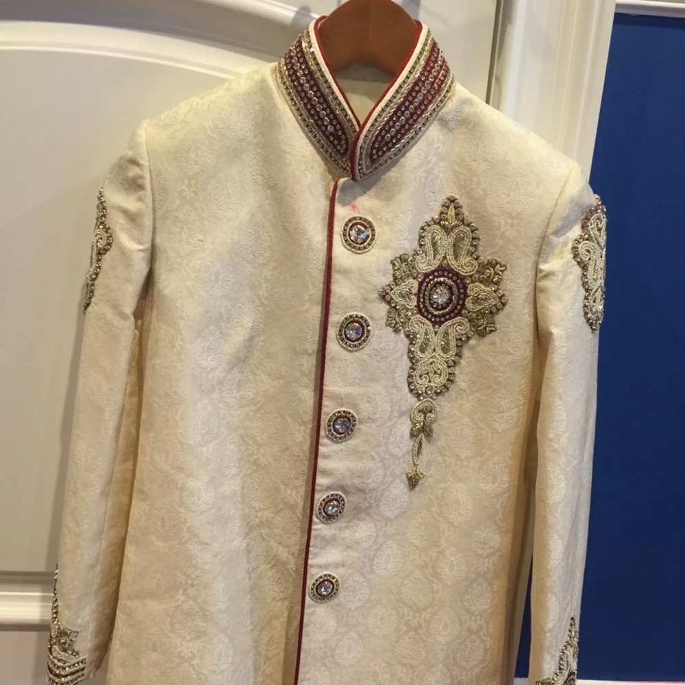 Tween boy’s cream Sherwani jacket with deep red trim, pants and shoes to match.